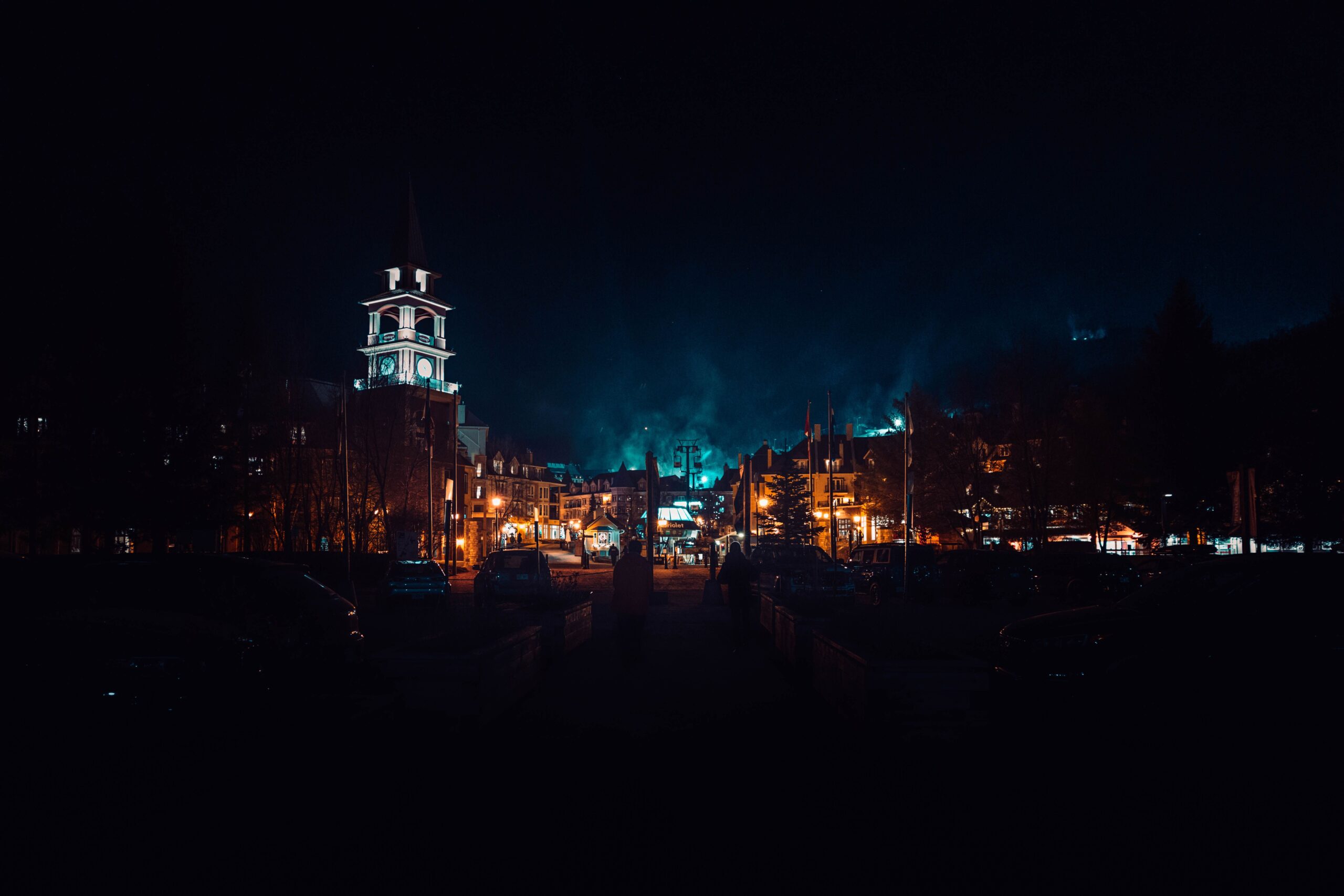 A breathtaking view of the illuminated clock tower of Montreal, Canada, against the night skyline